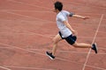 Athletic Asian runner sprinter crossing the finish line. Royalty Free Stock Photo