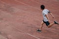 Athletic Asian runner sprinter crossing the finish line.