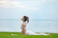 Athletic Asian young woman practice Cobra Pose on green grass and beach in Tropical island,Feeling comfortable