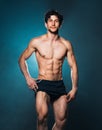 Athletic attractive man after fitness exersise on the blue Royalty Free Stock Photo