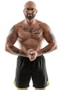 Athletic bald, tattooed man in black shorts is posing isolated on white background. Close-up portrait. Royalty Free Stock Photo