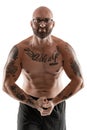 Athletic bald, tattooed man in black shorts is posing isolated on white background. Close-up portrait.