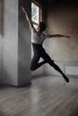 Athletic ballet dancer with perfect body performing over studio background Royalty Free Stock Photo