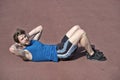 Athletic bearded man with muscular body doing exercises for abdominal