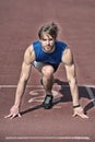 Athletic bearded man with muscular body stretching on running track Royalty Free Stock Photo