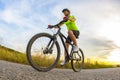 Athletic beautiful cyclist rides a bicycle on the road against the backdrop of beautiful nature. hobbies and sports Royalty Free Stock Photo