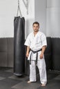 Athletic black belt karate standing next a boxing ba Royalty Free Stock Photo