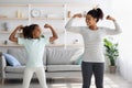 Athletic black mom and kid doing morning exercises together Royalty Free Stock Photo