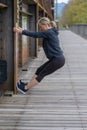 Athletic blond woman doing stretching exercises