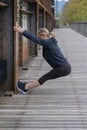 Athletic blond woman doing stretching exercises