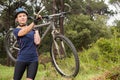 Athletic blonde carrying her mountain bike