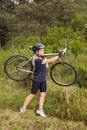 Athletic blonde carrying her mountain bike