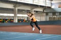 Athletic blonde woman training at indoor stadium Royalty Free Stock Photo
