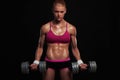 Athletic bodybuilder woman with dumbbells.beautiful blonde girl with muscles