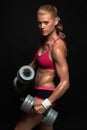 Athletic bodybuilder woman with dumbbells. beautiful blonde girl with muscles