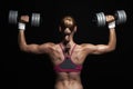 Athletic bodybuilder young woman with dumbbells.blonde girl with muscles