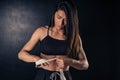 Athletic boxer female wraps bandages on her hands puts gloves for fight in gym. Workout, fitness concept Royalty Free Stock Photo