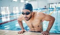 Athletic, breathing and man swimming for fitness, training and race in a stadium pool. Tired, sports and face of an Royalty Free Stock Photo