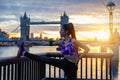 Athletic city woman does her stretches in front of Tower Bridge in London