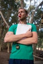 Athletic coach blowing whistle in the forest Royalty Free Stock Photo