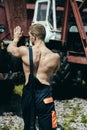 Athletic concept. Athletic man push heavy machinery. Worker with athletic torso. Athletic activity