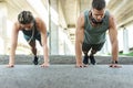 Athletic couple and fitness training outdoors. Man and woman doing push-ups exercise. Royalty Free Stock Photo