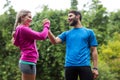 Athletic couple holding hands in forest Royalty Free Stock Photo