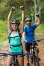 Athletic couple standing with mountain bike in forest Royalty Free Stock Photo