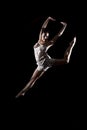 Athletic dancer leaping through the air in pose