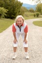 Athletic elderly woman working out on a rural road Royalty Free Stock Photo