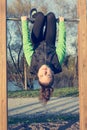 Athletic female doing exercise at outdoor fitness pullup bar station.