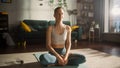 Athletic Female Exercising, Practising Meditation in the Morning in Her Bright Sunny Room at Home Royalty Free Stock Photo