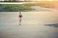 Athletic female long distance runner out jogging