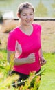 Athletic female in pink T-shirt is training Royalty Free Stock Photo