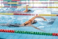 Female swimmer using freestyle technique in pool lane Royalty Free Stock Photo