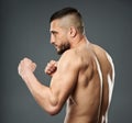 Athletic fighter posing on gray Royalty Free Stock Photo