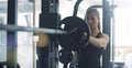 Athletic fit woman weightlifting at the gym