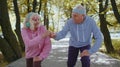 Athletic fitness senior elderly sport runner man woman training cardio workout in park at morning Royalty Free Stock Photo