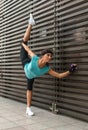 Athletic flexible young woman doing yoga standing split exercise