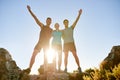 Athletic friends posing triumphantly on a mountain together