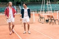 athletic friends with wooden rackets walking