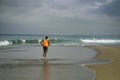 Athletic full body portrait of young attractive and fit black afro American man running on the beach doing Summer fitness jogging Royalty Free Stock Photo