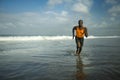 Athletic full body portrait of young attractive and fit black afro American man running on the beach doing Summer fitness jogging Royalty Free Stock Photo