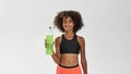 Athletic girl with bottle of green sport drink