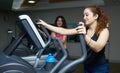 Athletic girl doing an ellipsoid in gym side view Royalty Free Stock Photo