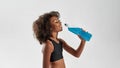 Athletic girl drinking sport drink from bottle Royalty Free Stock Photo