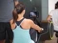 Athletic Girl Exercising on Rowing Machine at Gym: Fitness Equipment