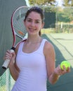 Athletic girl holding tennis racket and ball Royalty Free Stock Photo