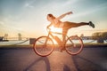 Athletic girl performing acrobatic riding on electric bike