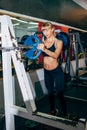 Athletic girl sets weight on barbell in the gym Royalty Free Stock Photo